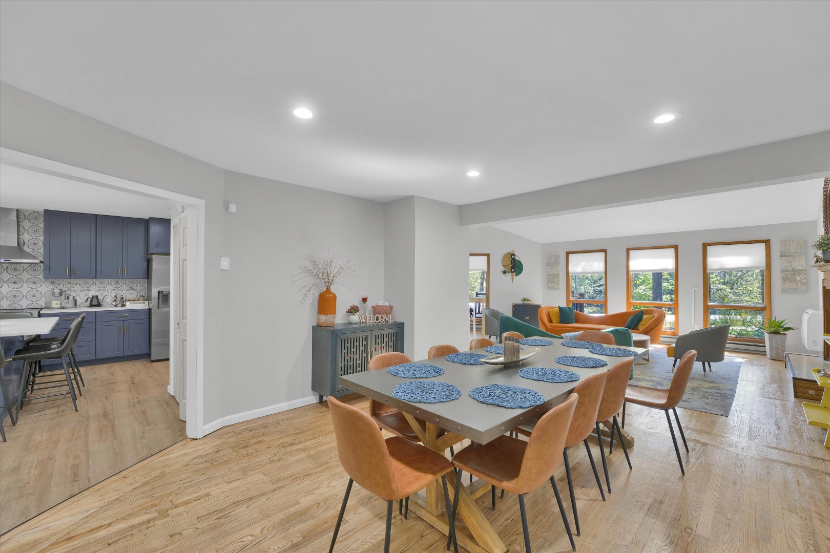 Gather for memorable group meals in this open-concept dining space, featuring a large 10-seater table seamlessly connecting the kitchen and living area.