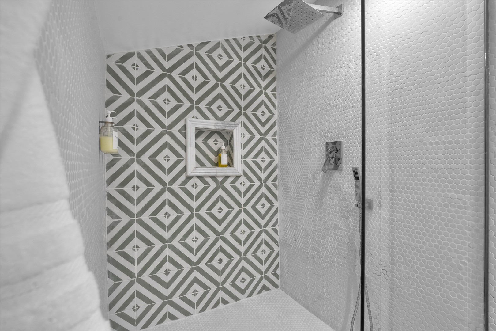 Custom geometric tile design elevates the walk-in shower experience.