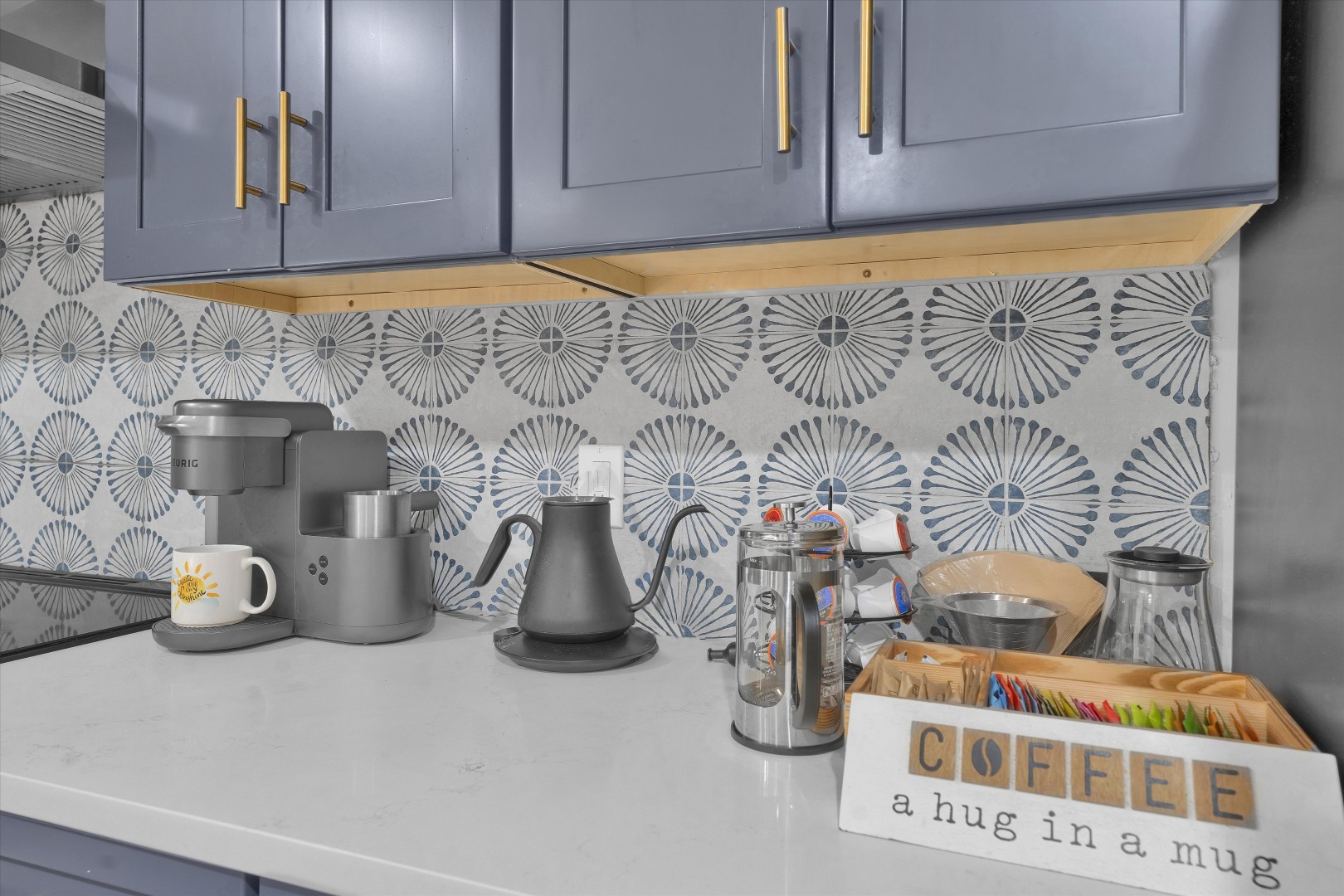 Start your morning right with a fully equipped coffee bar, featuring a Keurig machine, French press, and pour-over kettle.