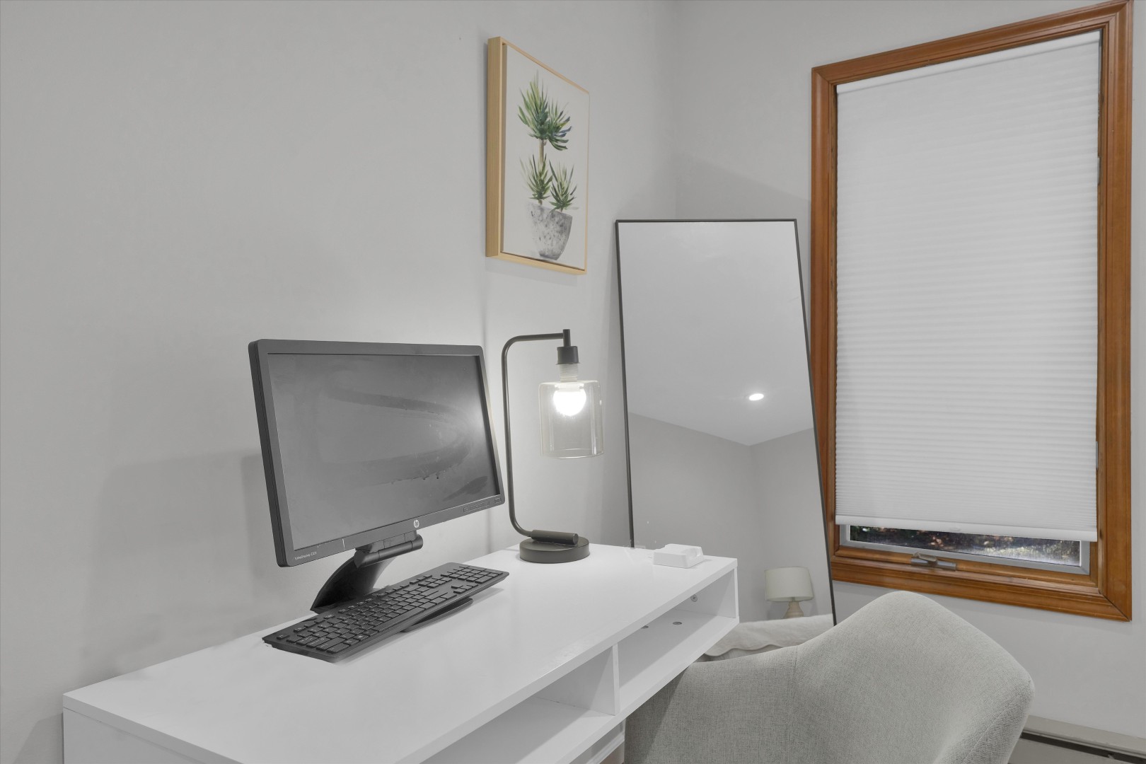 The perfect remote work setup - enjoy a dedicated desk space paired with serene, tree-lined window views.