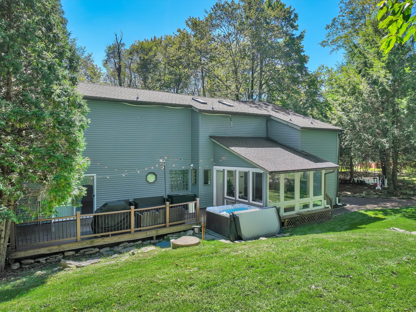 The ideal escape - soak in the hot tub, unwind in the light-filled sunroom, or relax on the lawn surrounded by nature.