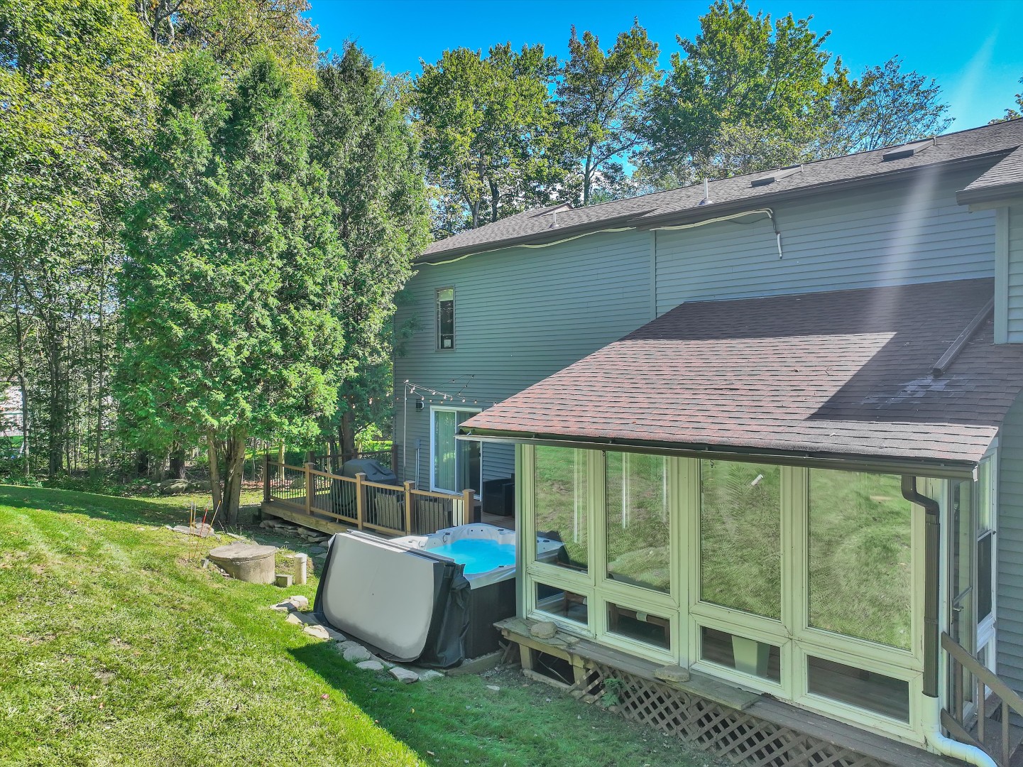 Walk out from the sunlit glass sunroom onto the green lawn, or take a relaxing soak in the private hot tub.