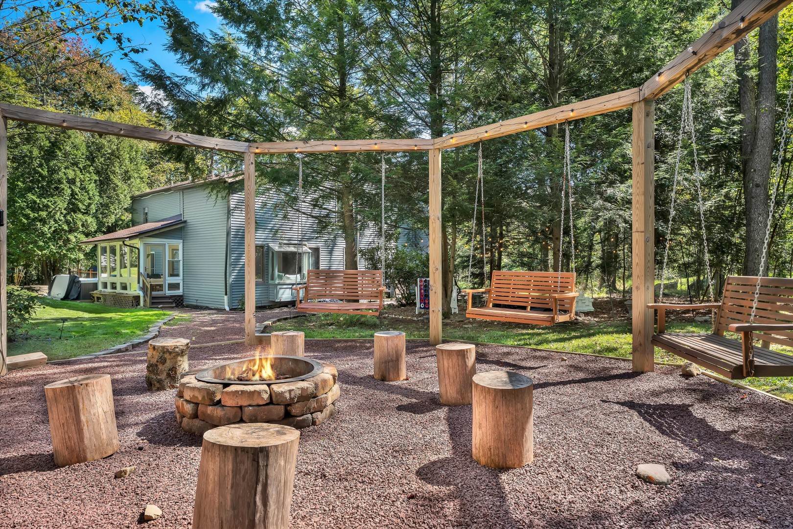 Gather around the fire pit for cozy evenings, with comfortable swings and plenty of space to relax under the trees.