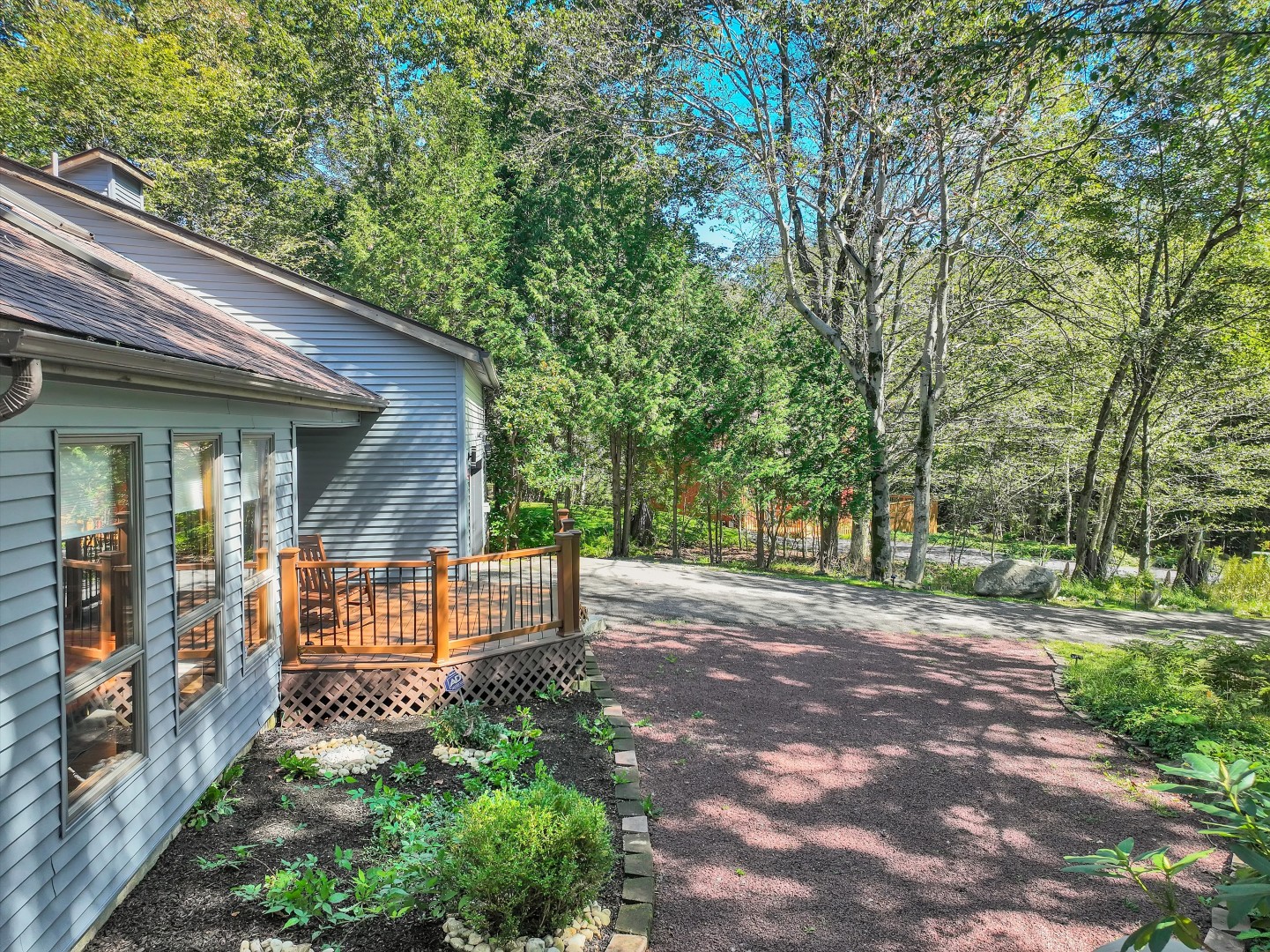 Nestled among the trees, offering a peaceful forest setting with ample private driveway parking.