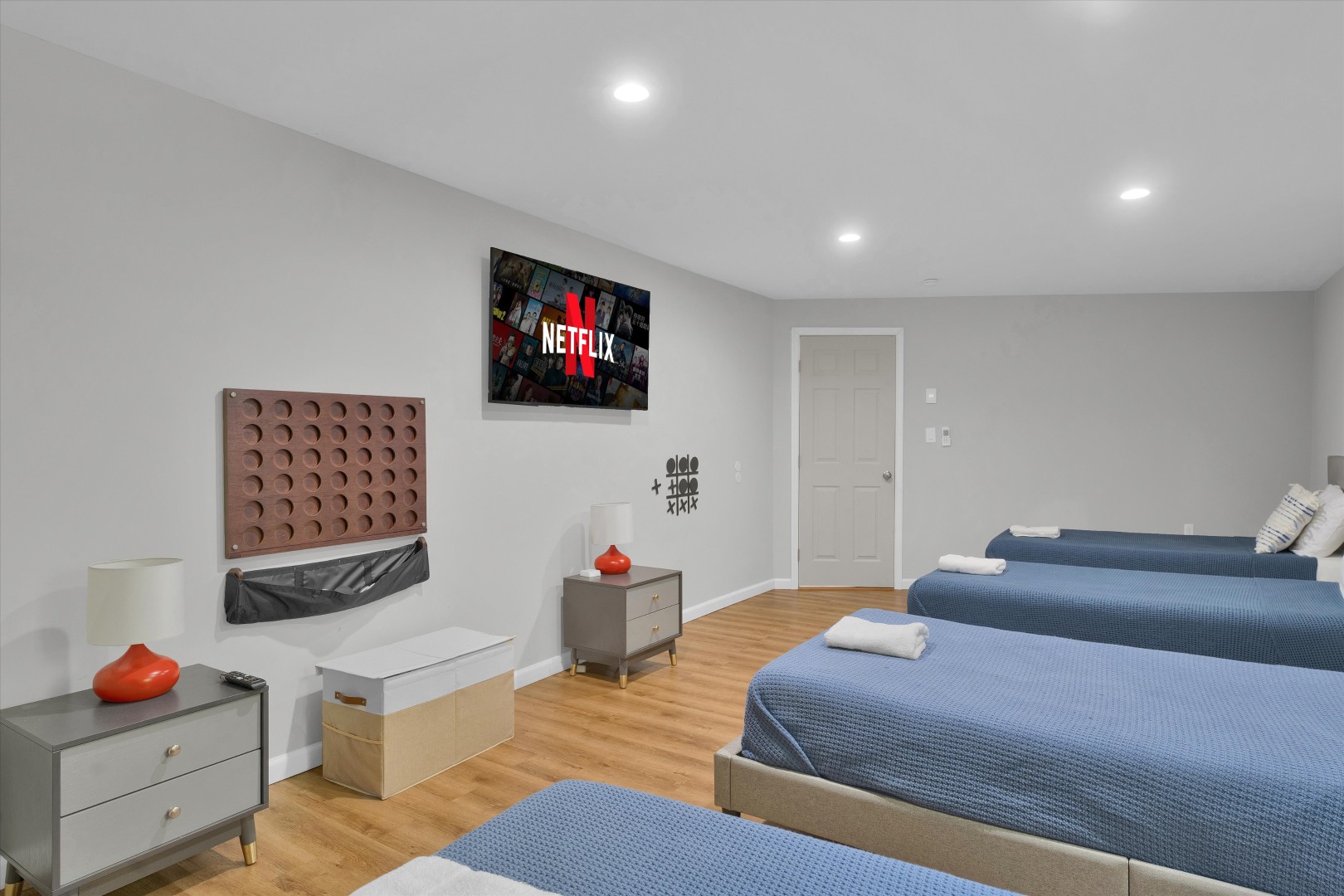 Turn bedtime into game time—featuring comfortable beds, a smart TV, and a wall-mounted Connect Four board.